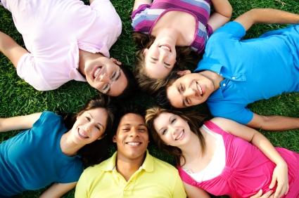 Photo of multiethnic group of adolescents smiling at the camera